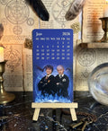 Calendar with characters on a decorative background with candles and symbols